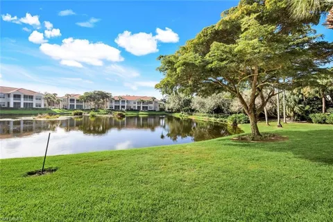 a view of a lake with houses in the back