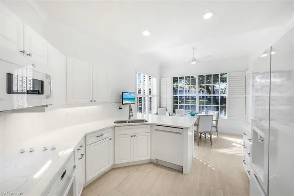 a kitchen with a sink cabinets and window