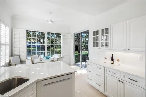 a kitchen with sink and large window