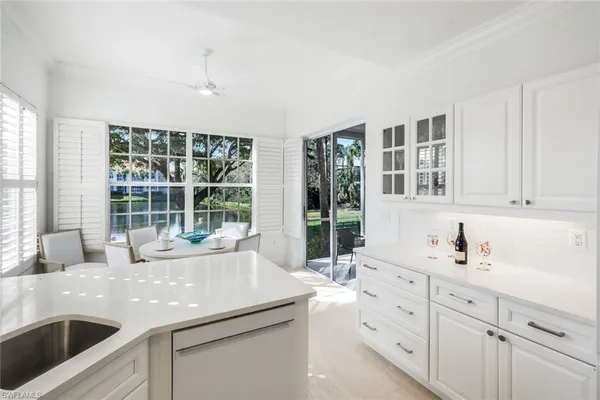 a kitchen with sink and large window