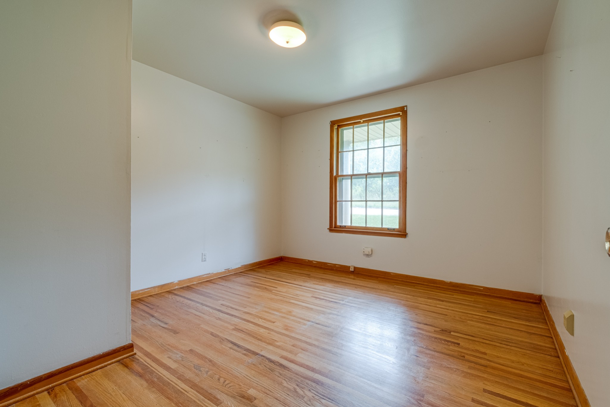 78 Tusculum Road Antioch, TN 37013 - Photo 11 of 27 an empty room with wooden floor and windows