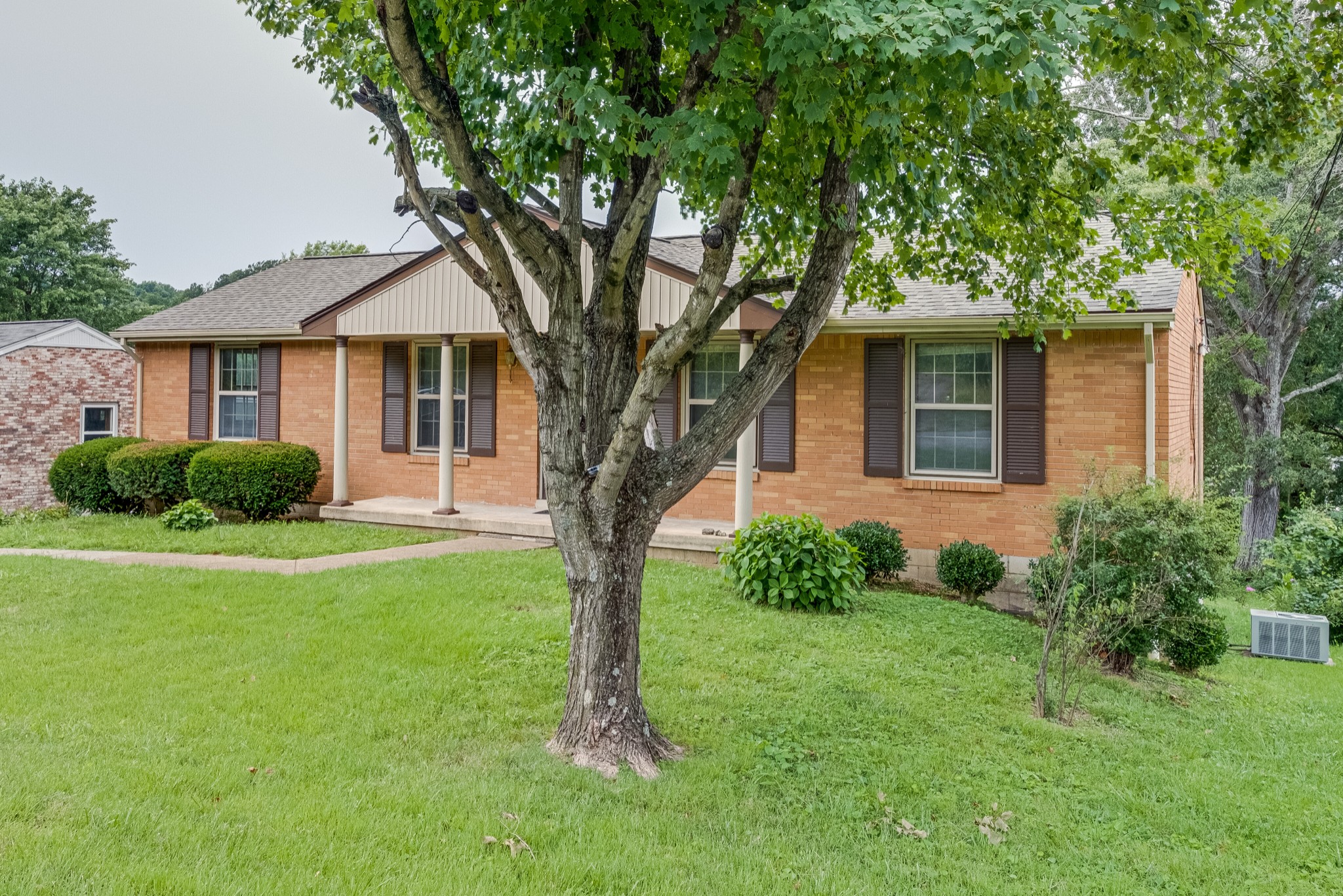 78 Tusculum Road Antioch, TN 37013 - Photo 3 of 27 a front view of a house with a garden