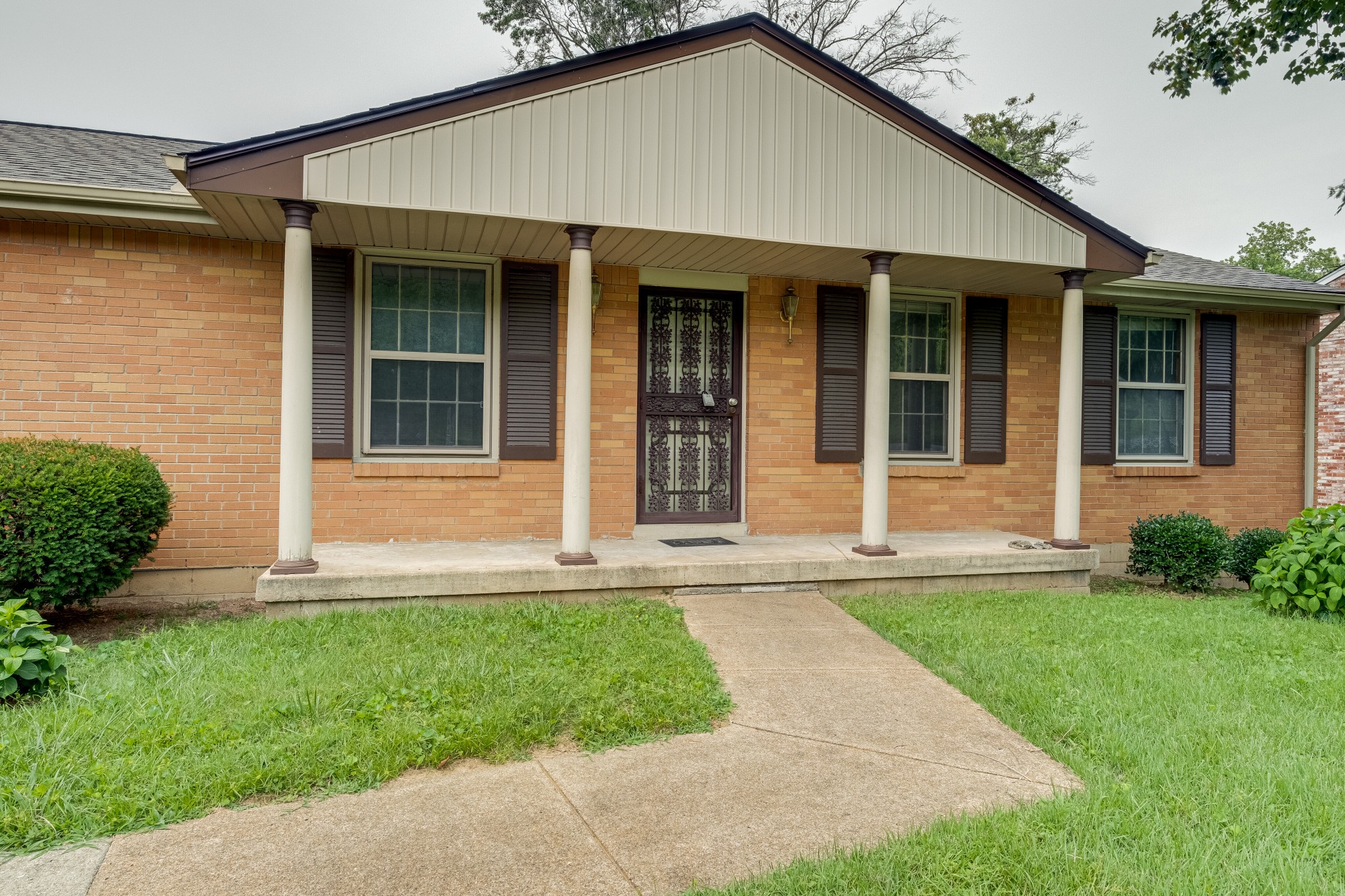 78 Tusculum Road Antioch, TN 37013 - Photo 4 of 27 a front view of a house with a yard and garage