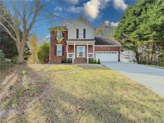a front view of a house with a garden
