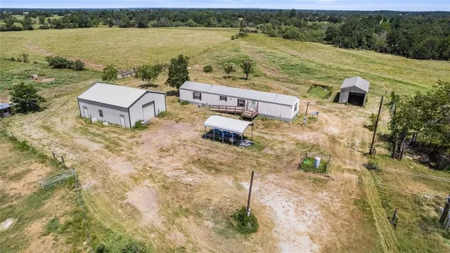 a kitchen with stainless steel appliances granite countertop a refrigerator a sink dishwasher a stove with wooden floor and cabinets