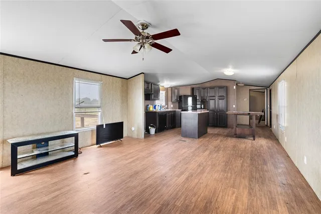 a kitchen with stainless steel appliances granite countertop a refrigerator a sink and a stove