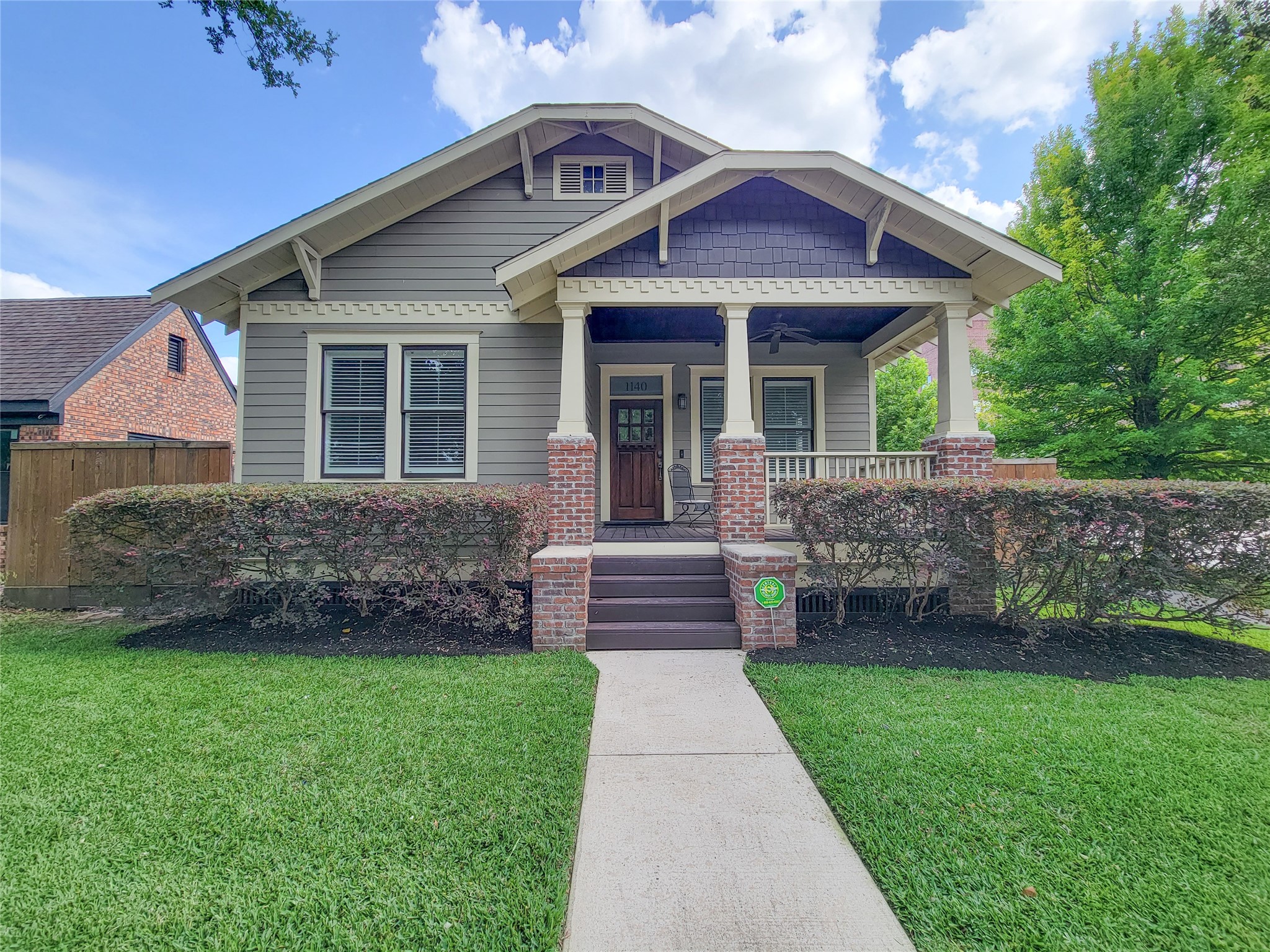 1140 West Cottage Street Houston, TX 77009 - Photo 2 of 37 a front view of a house with a garden and yard