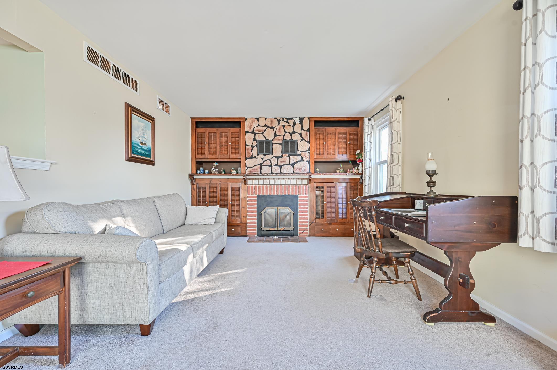16 MacDermott Place Brigantine, NJ 08203 - Photo 16 of 37 a living room with furniture a fireplace and a large window