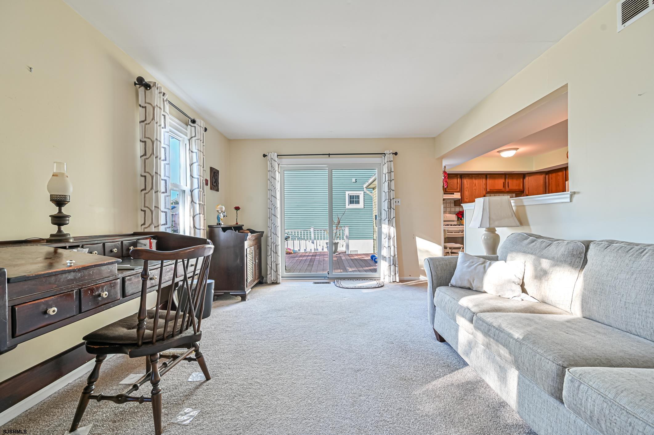 16 MacDermott Place Brigantine, NJ 08203 - Photo 18 of 37 a living room with furniture a large window and a table