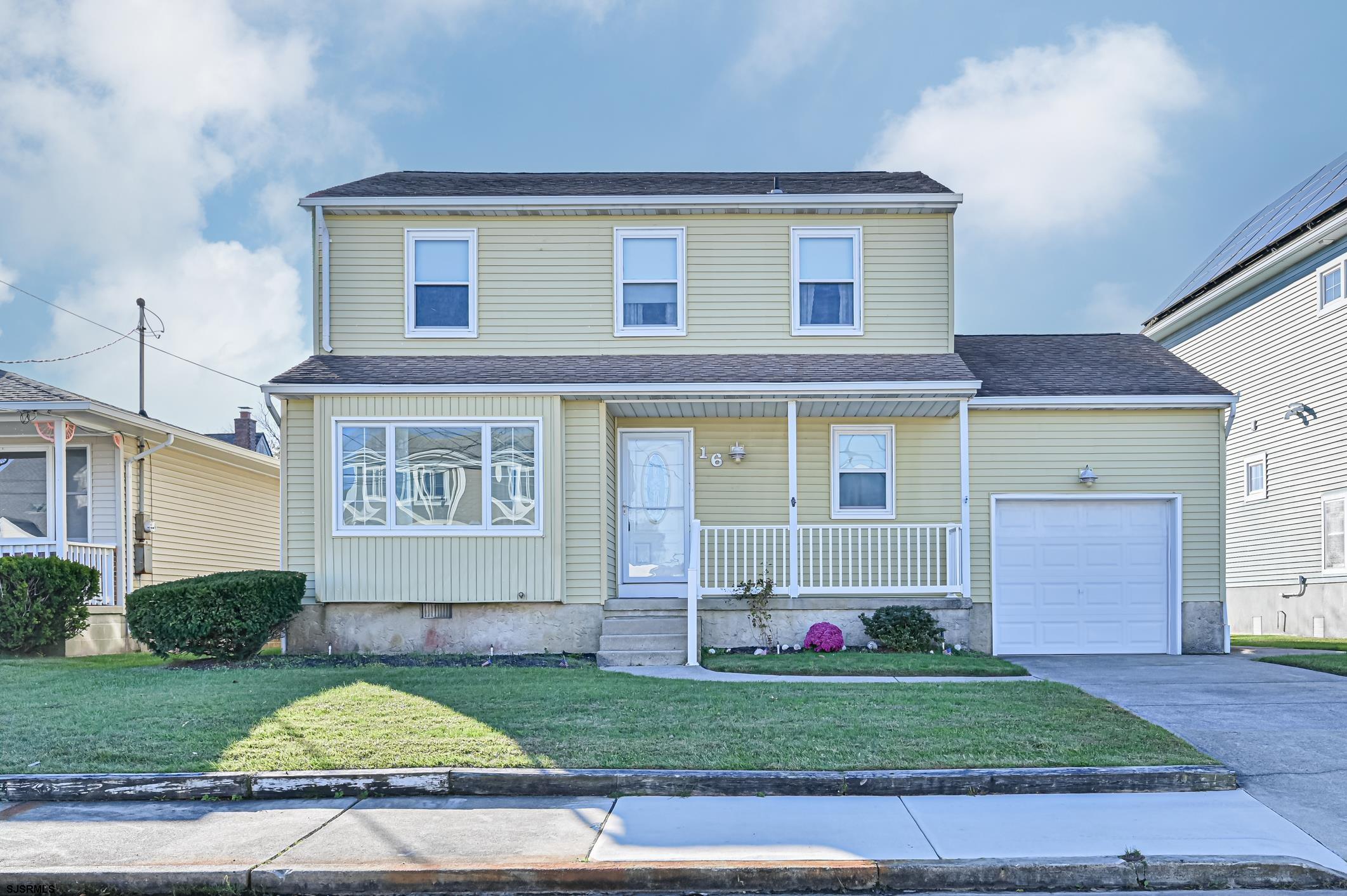 16 MacDermott Place Brigantine, NJ 08203 - Photo 2 of 37 a front view of a house with a yard and garage