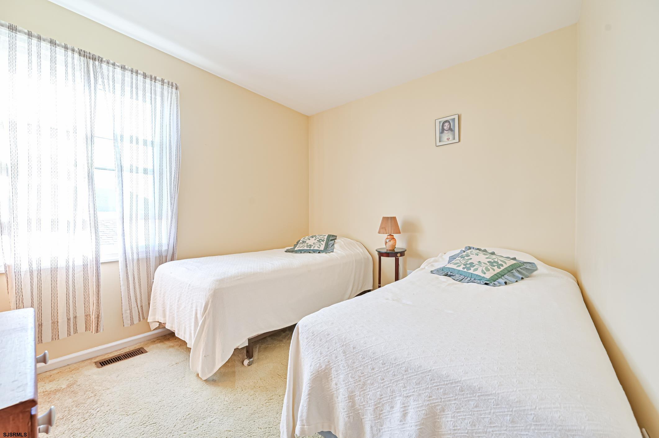 16 MacDermott Place Brigantine, NJ 08203 - Photo 22 of 37 a bedroom with two beds and a window