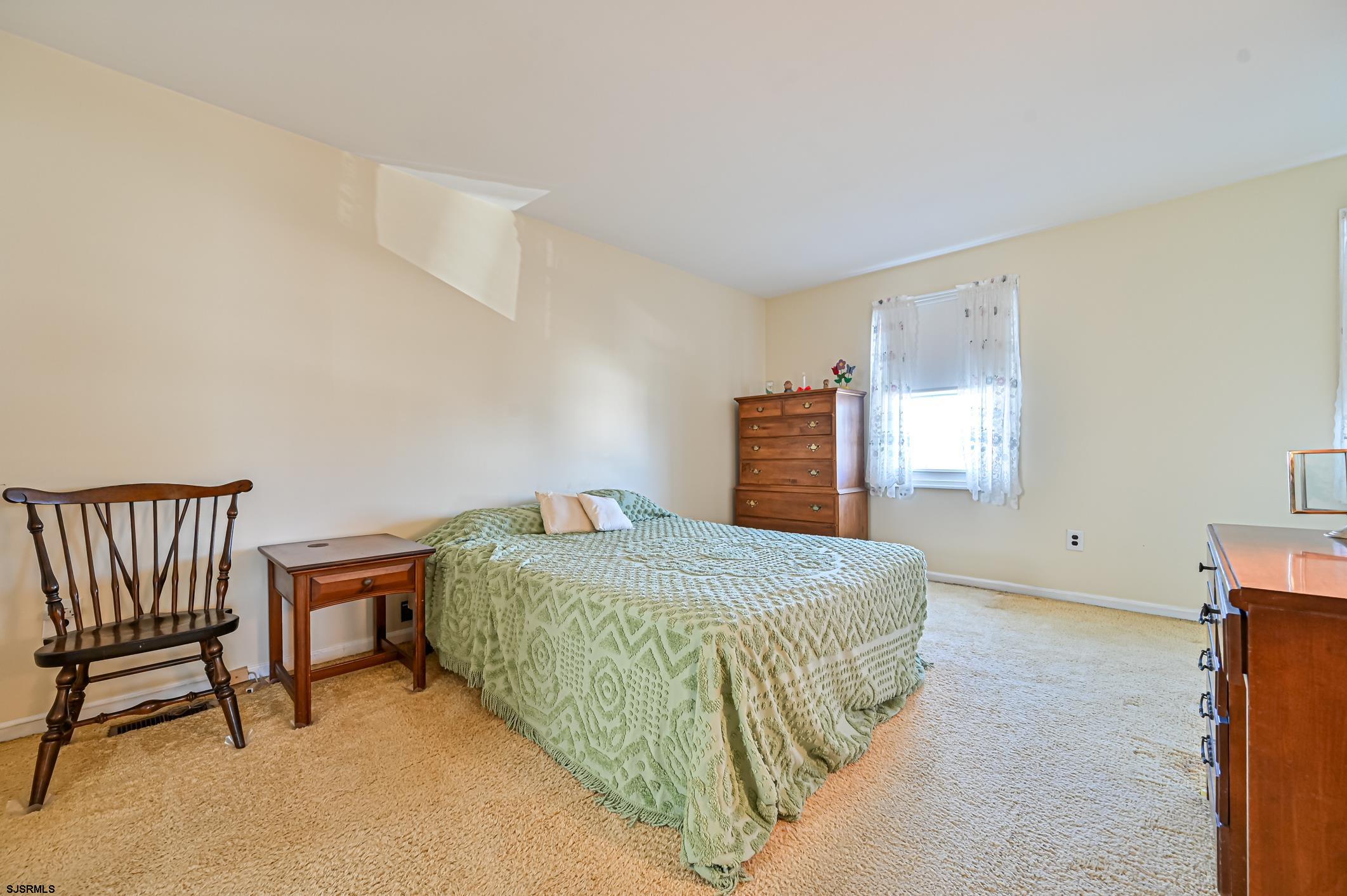 16 MacDermott Place Brigantine, NJ 08203 - Photo 25 of 37 a bedroom with a bed and a window