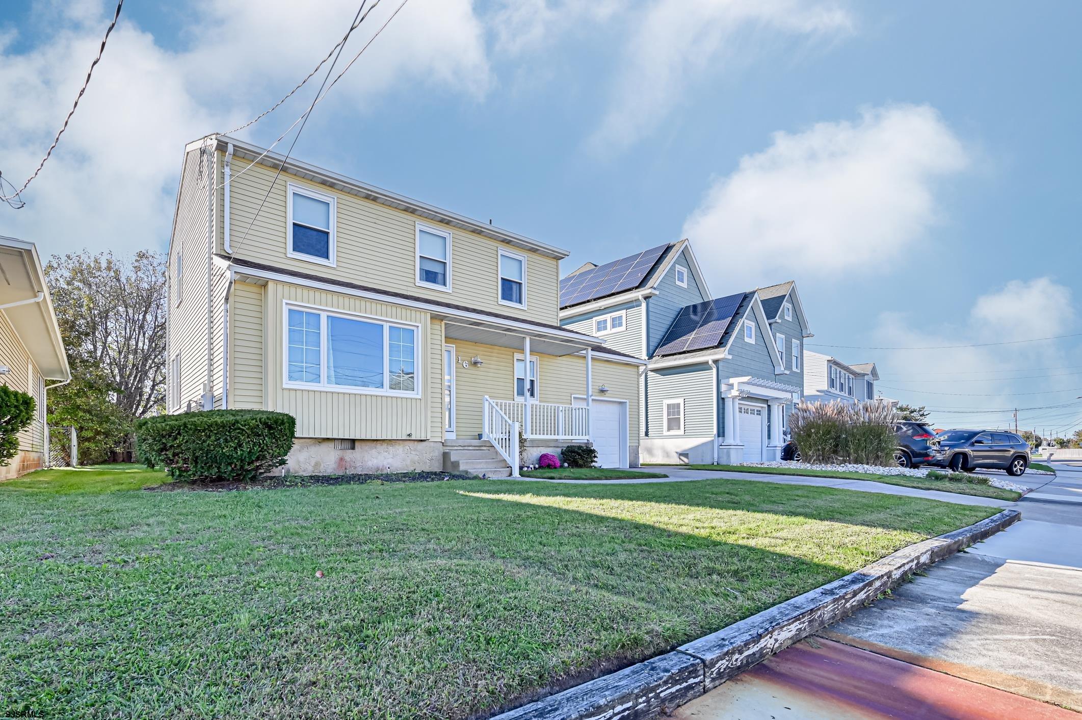 16 MacDermott Place Brigantine, NJ 08203 - Photo 27 of 37 a front view of house with yard and green space