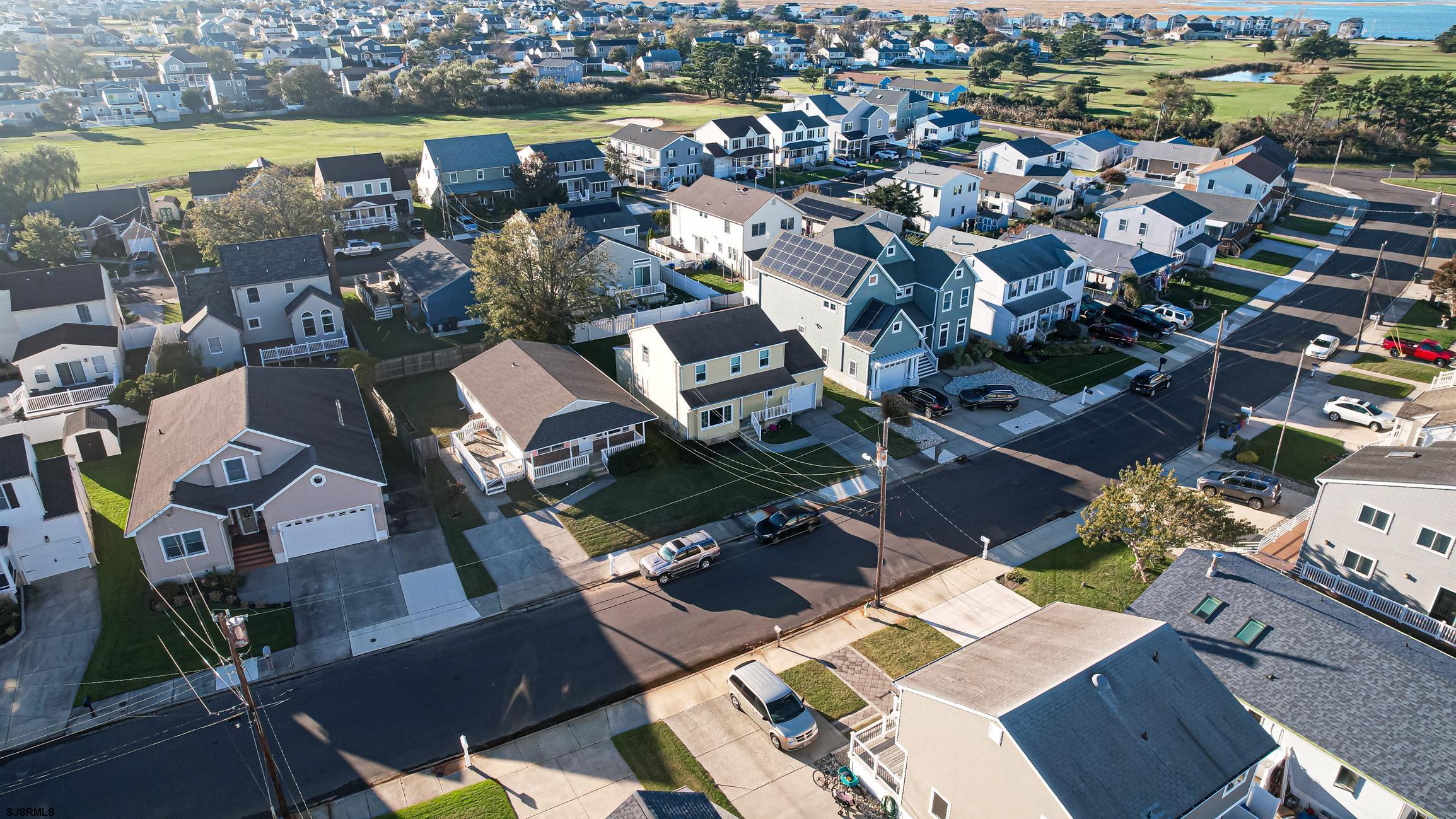 16 MacDermott Place Brigantine, NJ 08203 - Photo 33 of 37 an aerial view of a city with lots of residential buildings ocean and mountain view in back