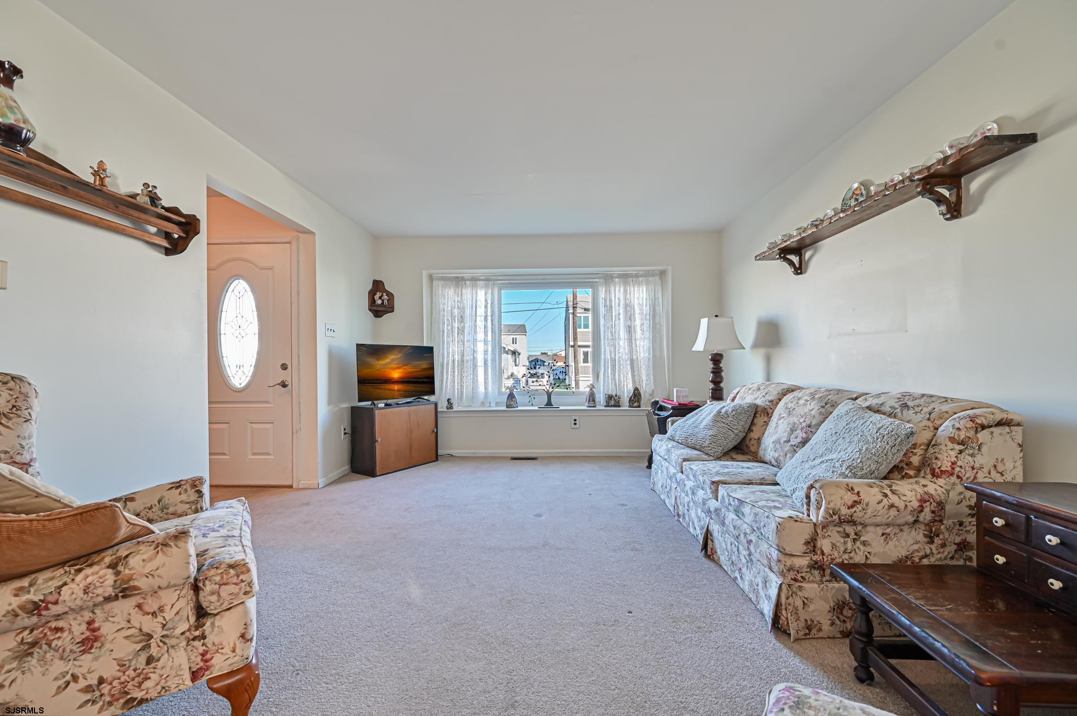 16 MacDermott Place Brigantine, NJ 08203 - Photo 8 of 37 a living room with furniture and a flat screen tv