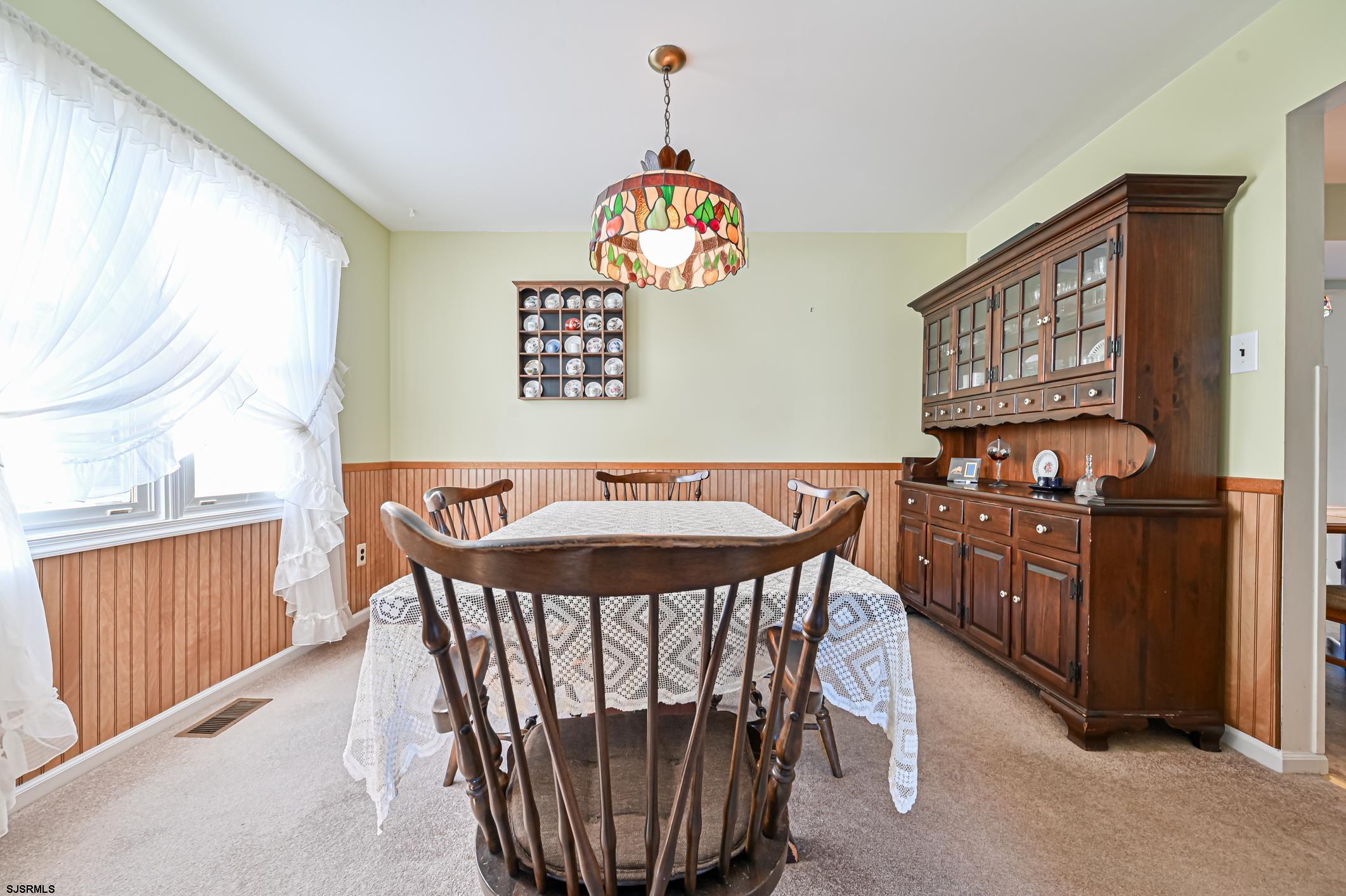 16 MacDermott Place Brigantine, NJ 08203 - Photo 9 of 37 a view of a dining room with furniture window and wooden floor