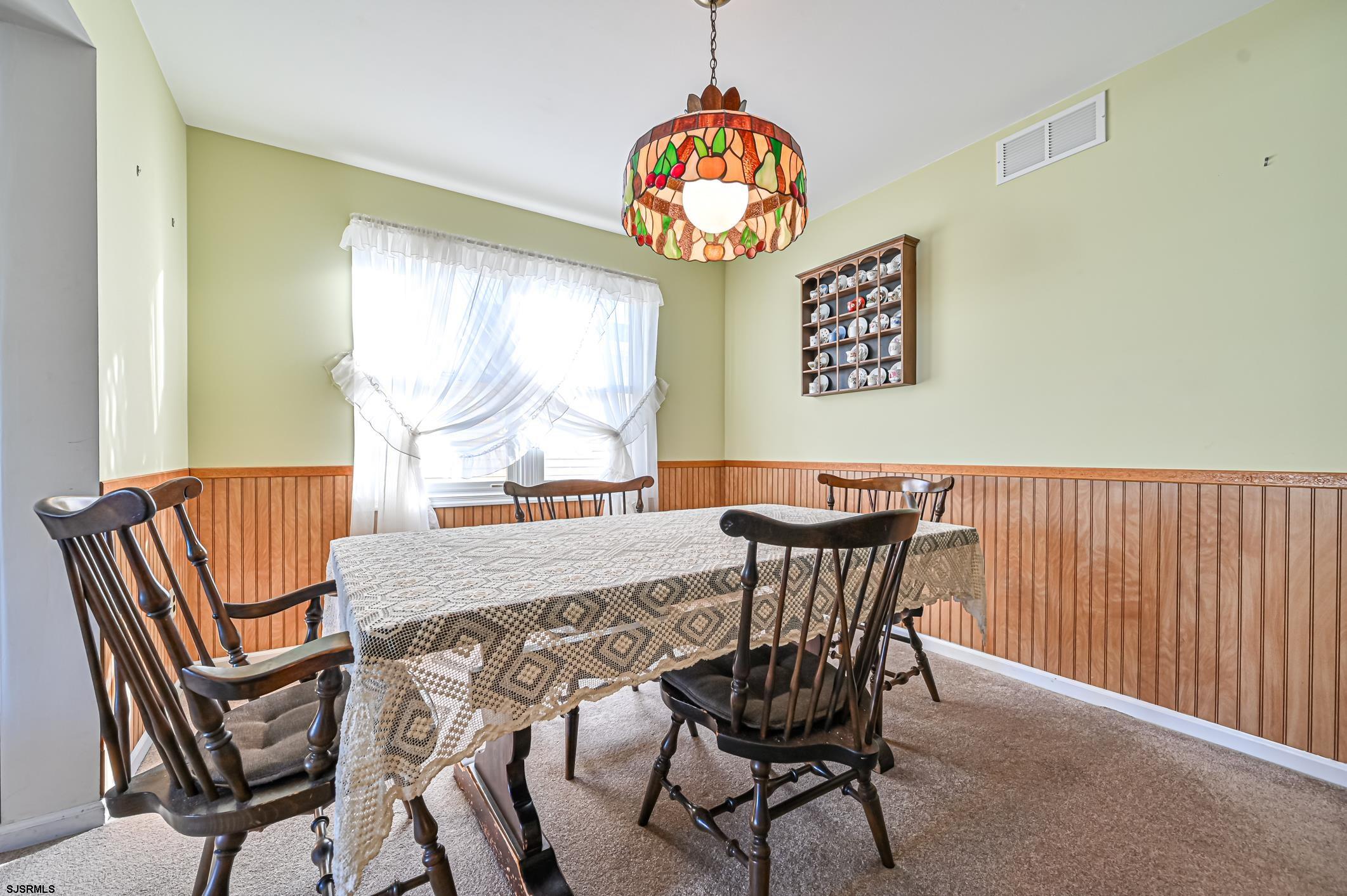 16 MacDermott Place Brigantine, NJ 08203 - Photo 10 of 37 a view of a dining room with furniture window and outside view