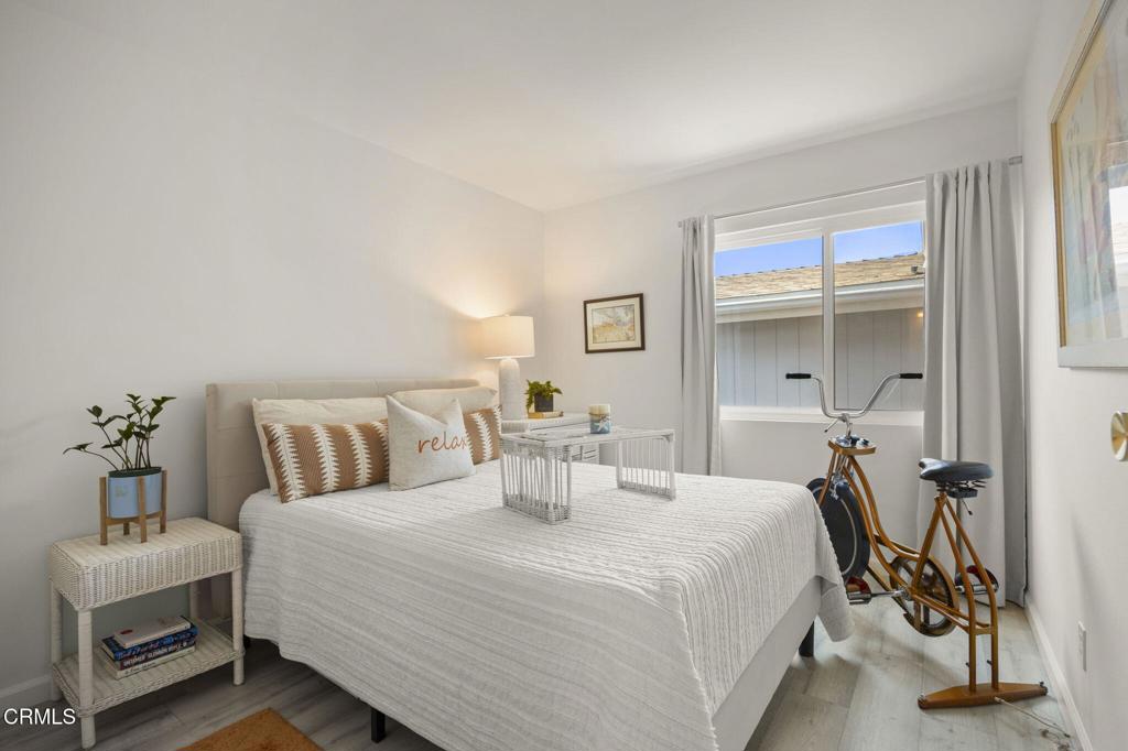400 Dewberry Lane, Unit 101 Oxnard, CA 93036 - Photo 16 of 37 a bedroom with a bed and a mirror
