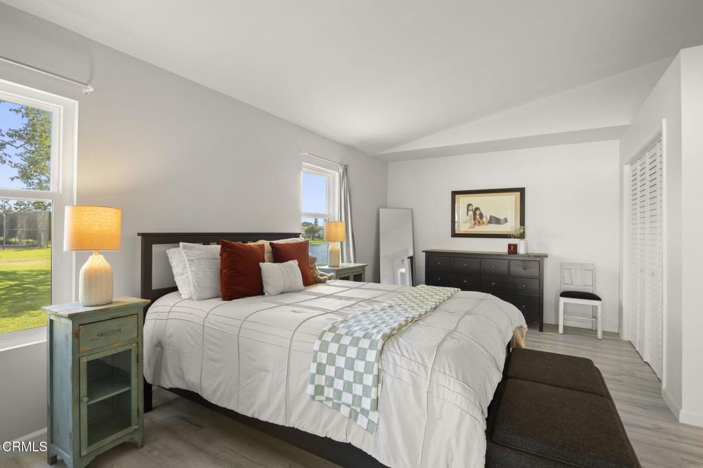 400 Dewberry Lane, Unit 101 Oxnard, CA 93036 - Photo 22 of 37 a bedroom with a bed and a lamp