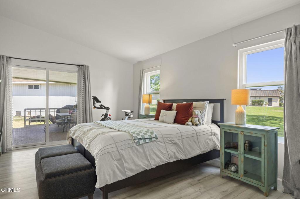 400 Dewberry Lane, Unit 101 Oxnard, CA 93036 - Photo 23 of 37 a bedroom with a bed and a lamp next to a window