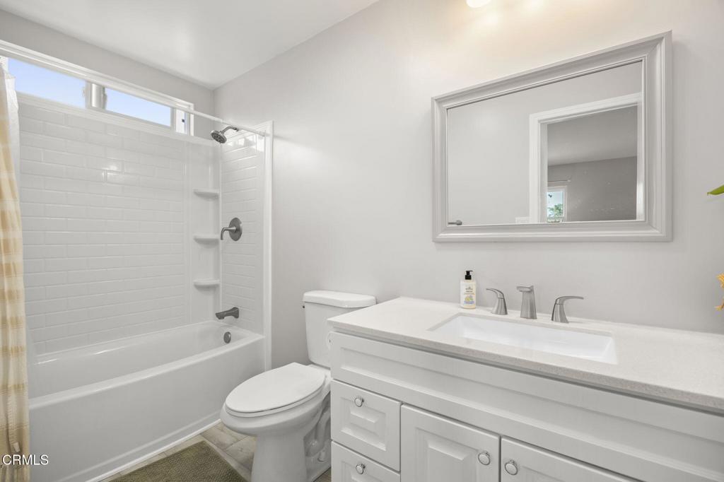 400 Dewberry Lane, Unit 101 Oxnard, CA 93036 - Photo 24 of 37 a bathroom with a toilet sink vanity tub and shower