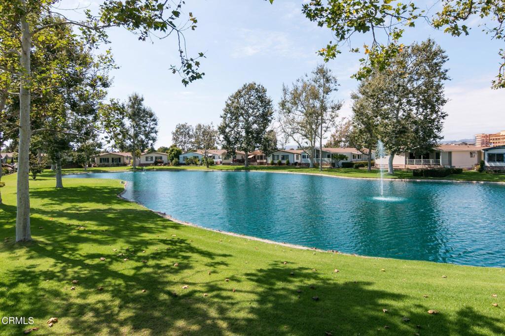 400 Dewberry Lane, Unit 101 Oxnard, CA 93036 - Photo 30 of 37 a view of a lake with houses in the back