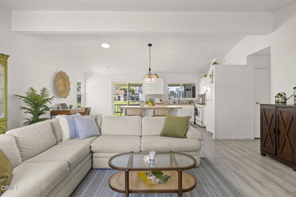 400 Dewberry Lane, Unit 101 Oxnard, CA 93036 - Photo 8 of 37 a living room with furniture and a chandelier