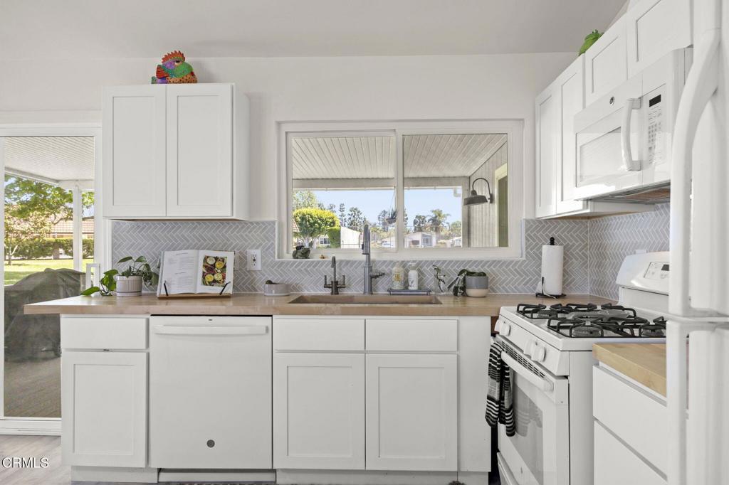 400 Dewberry Lane, Unit 101 Oxnard, CA 93036 - Photo 9 of 37 a kitchen with white cabinets and appliances