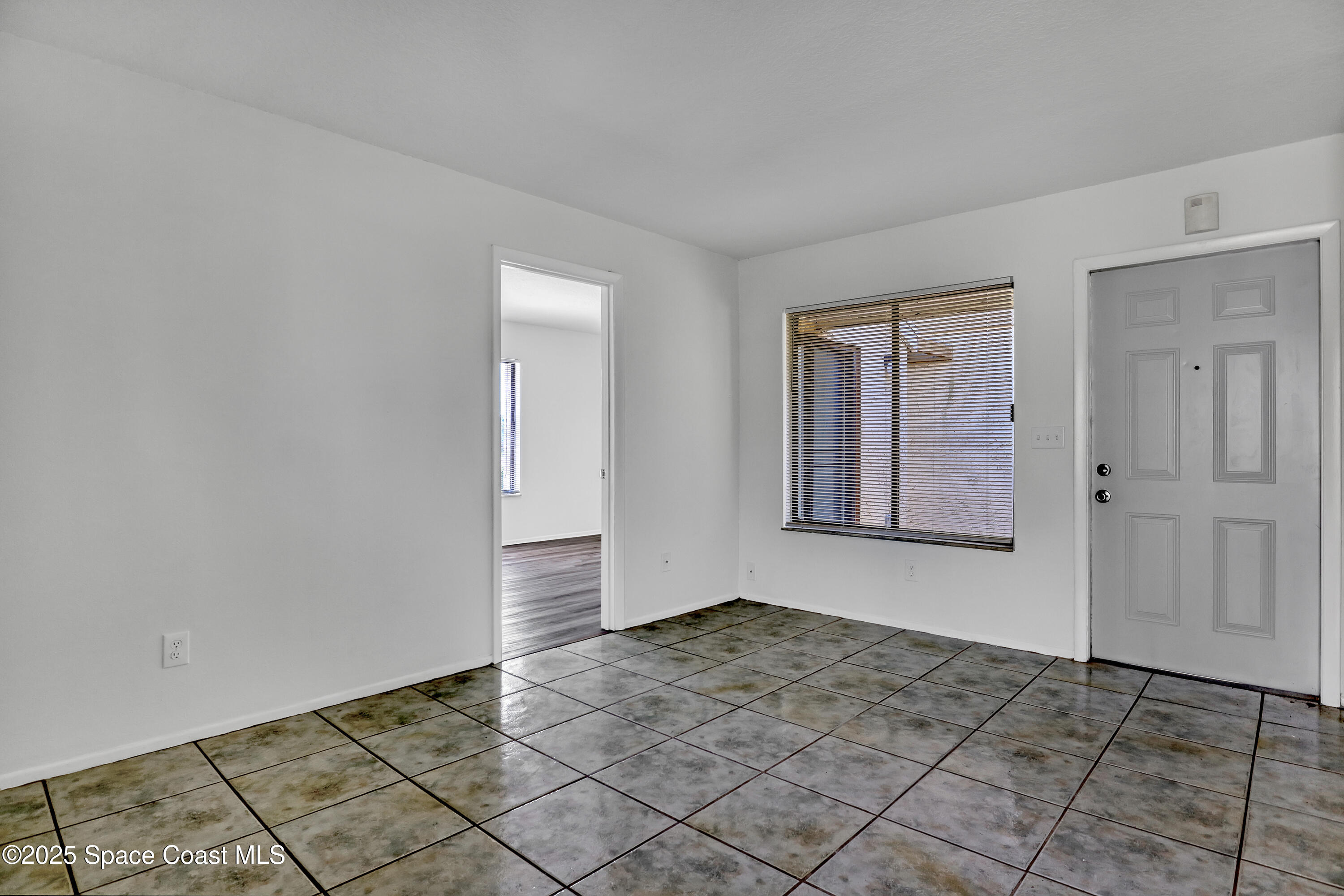 1031 Abada Court Northeast, Unit 110 Palm Bay, FL 32905 - Photo 13 of 33 a view of an empty room and window