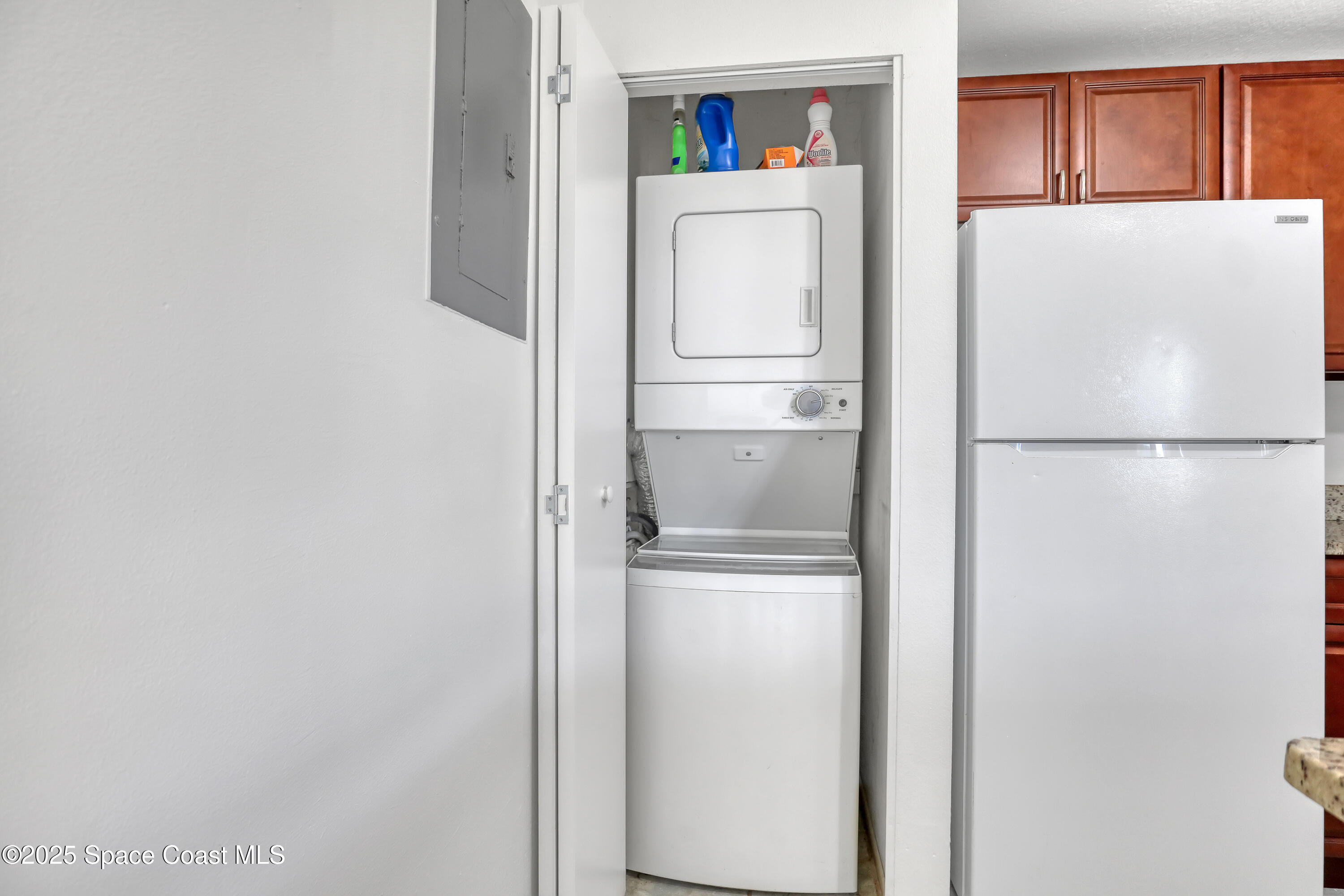 1031 Abada Court Northeast, Unit 110 Palm Bay, FL 32905 - Photo 17 of 33 a white refrigerator freezer and a stove sitting inside of a kitchen