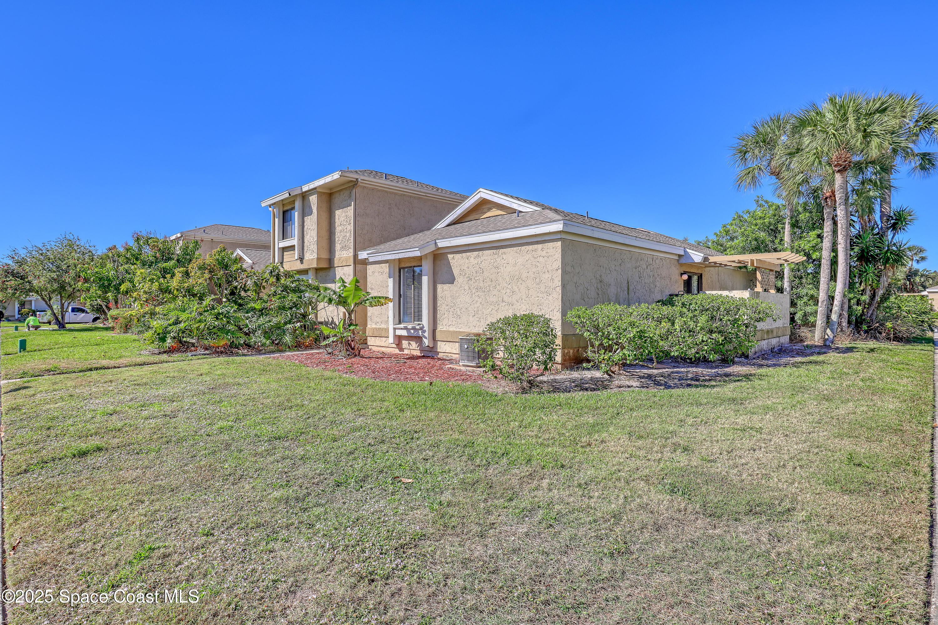 1031 Abada Court Northeast, Unit 110 Palm Bay, FL 32905 - Photo 2 of 33 a front view of a house with garden