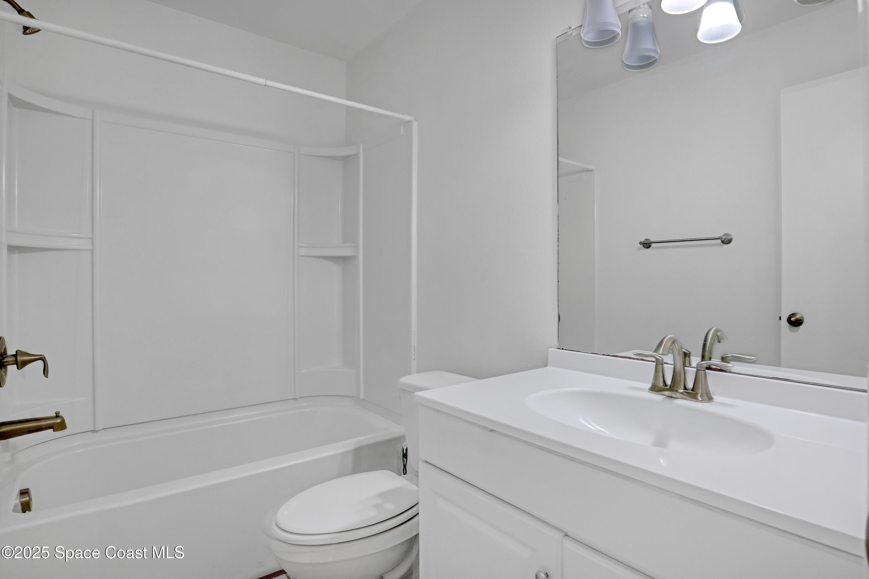 1031 Abada Court Northeast, Unit 110 Palm Bay, FL 32905 - Photo 25 of 33 a bathroom with a sink a toilet and a bathtub