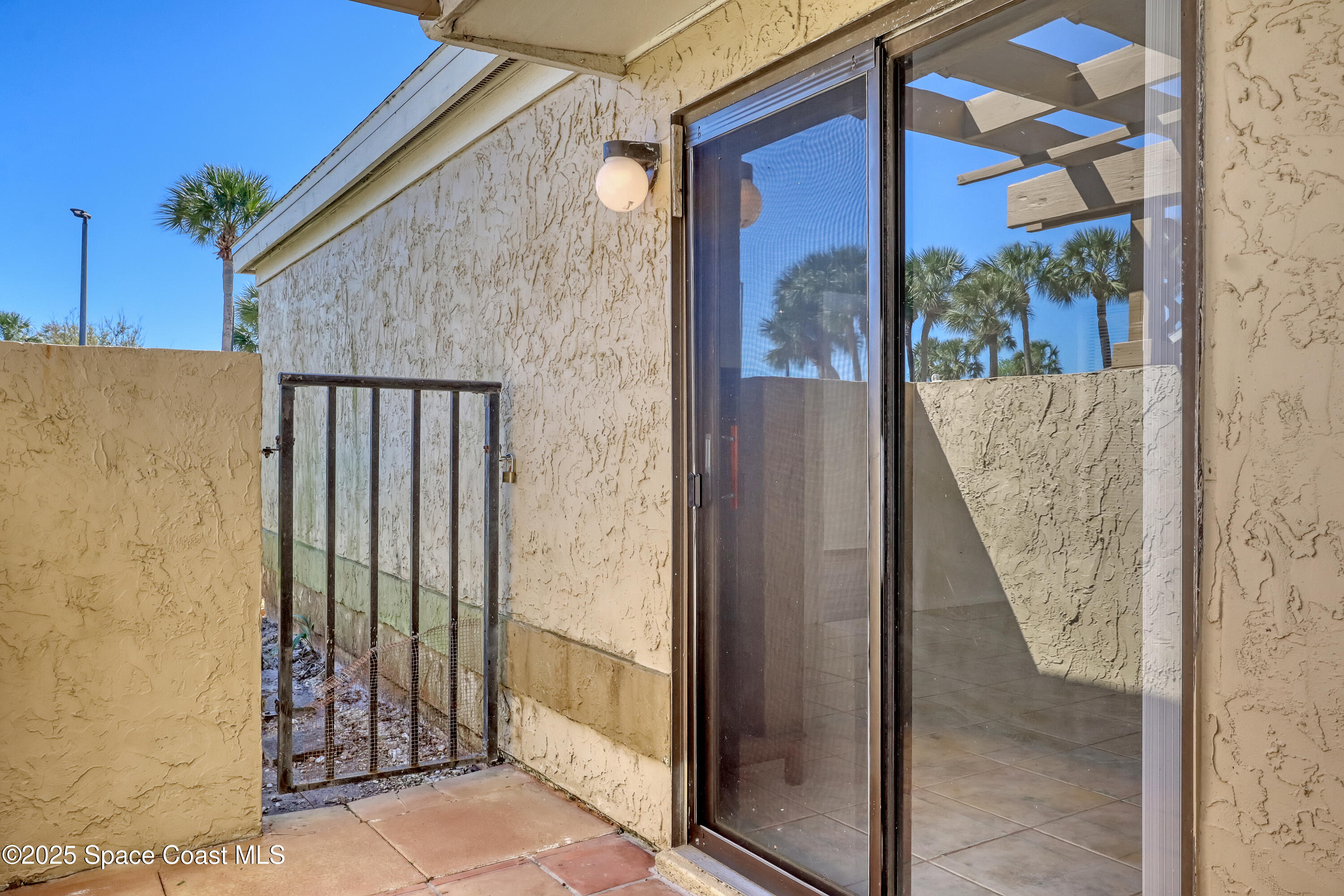 1031 Abada Court Northeast, Unit 110 Palm Bay, FL 32905 - Photo 26 of 33 a view of a balcony with wooden floor