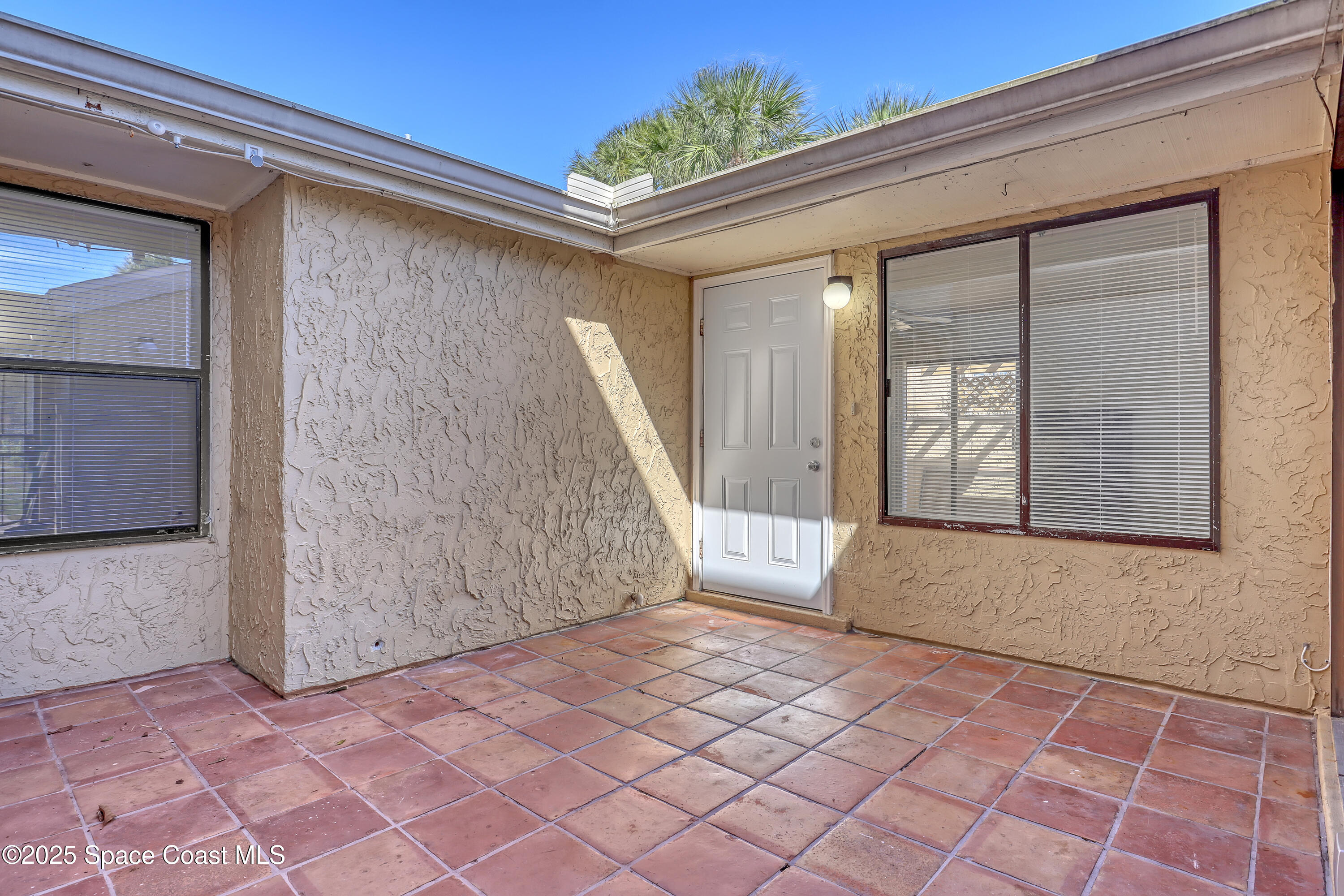 1031 Abada Court Northeast, Unit 110 Palm Bay, FL 32905 - Photo 5 of 33 an empty room with windows