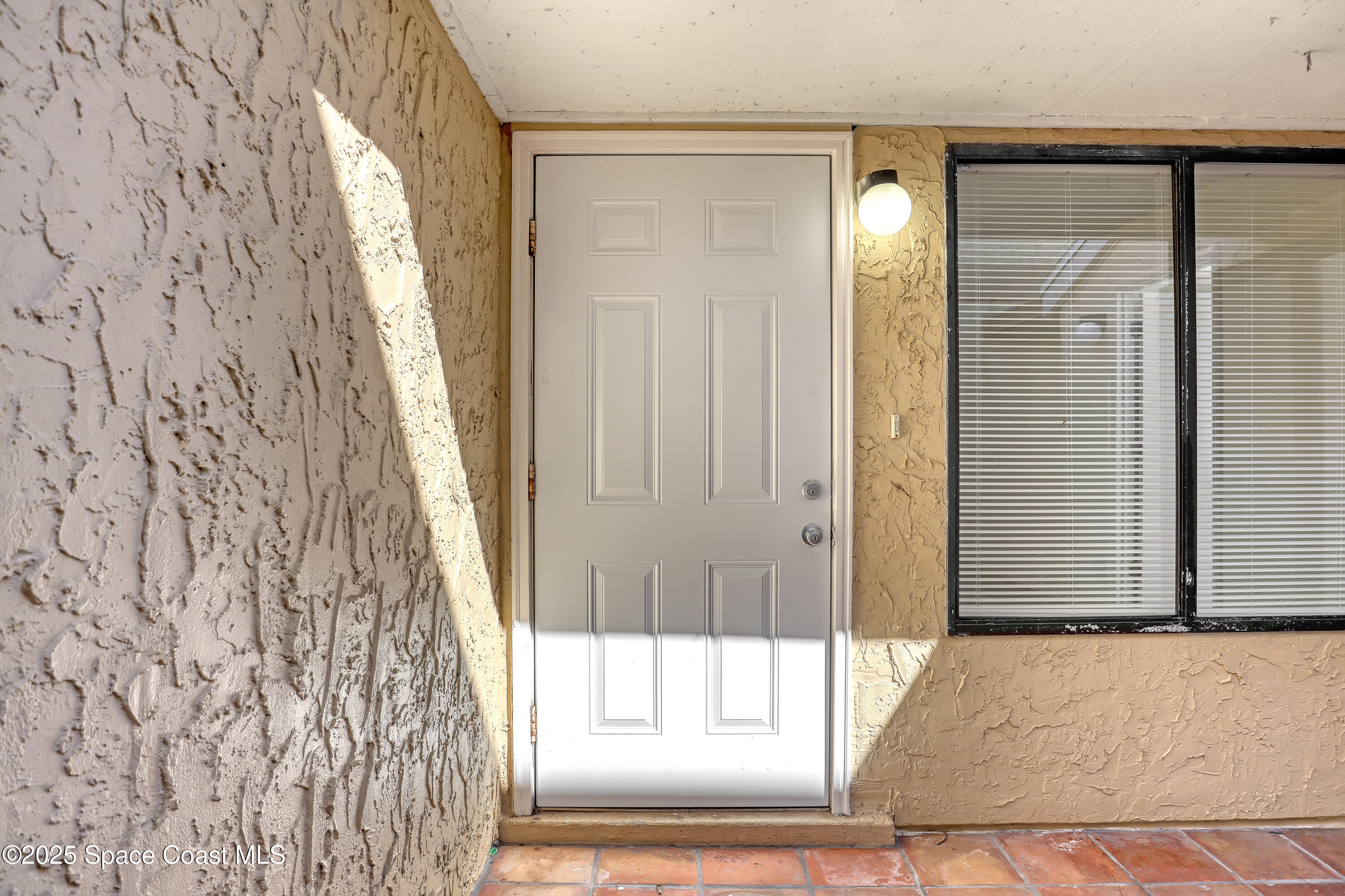 1031 Abada Court Northeast, Unit 110 Palm Bay, FL 32905 - Photo 7 of 33 a view of a bathroom with a glass door