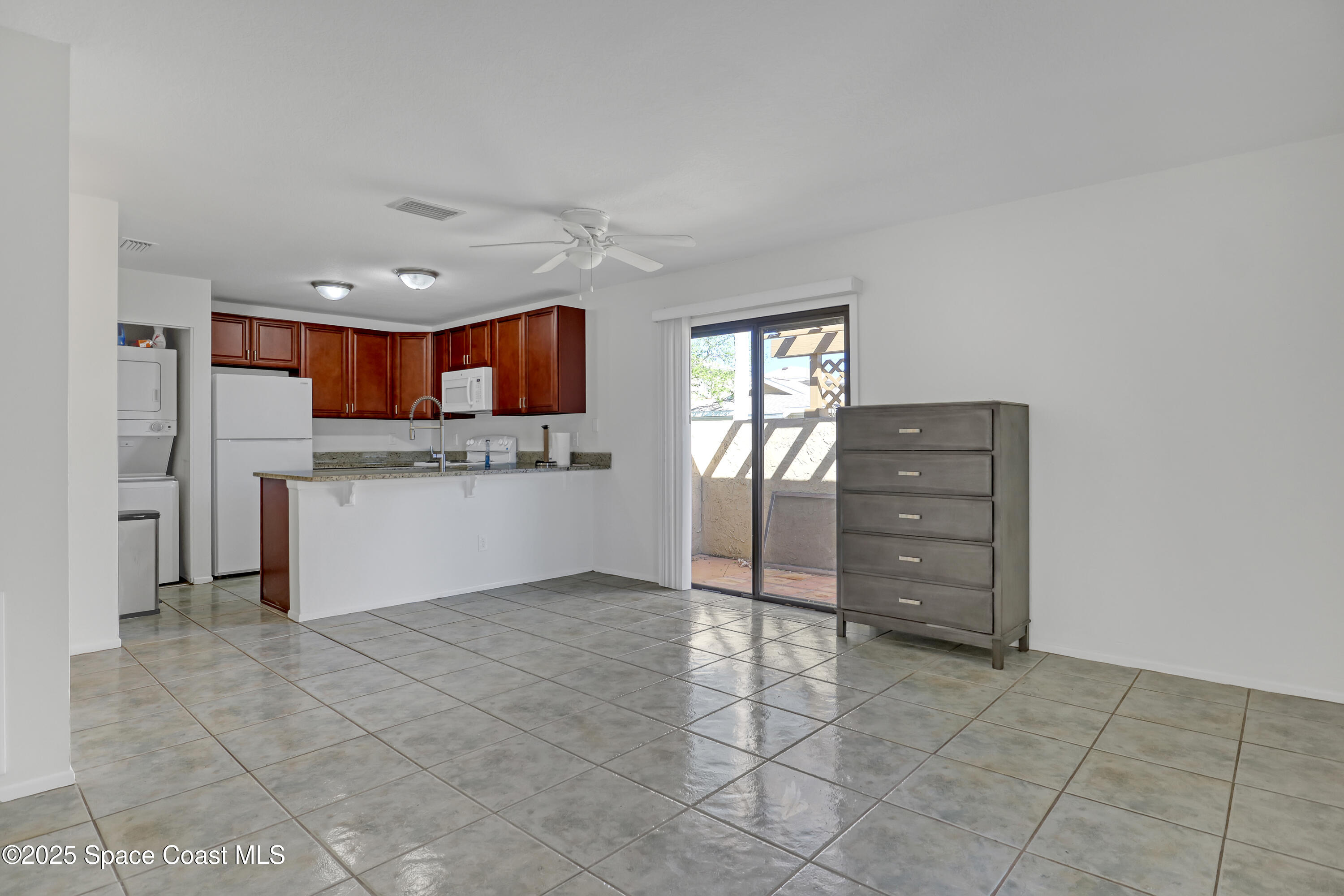 1031 Abada Court Northeast, Unit 110 Palm Bay, FL 32905 - Photo 9 of 33 a kitchen with cabinets and window