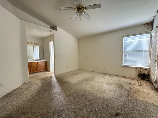 an empty room with windows and closet