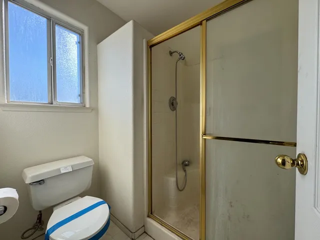 a white toilet sitting next to a bathroom sink