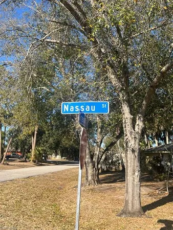 a street sign on a sidewalk next to a road