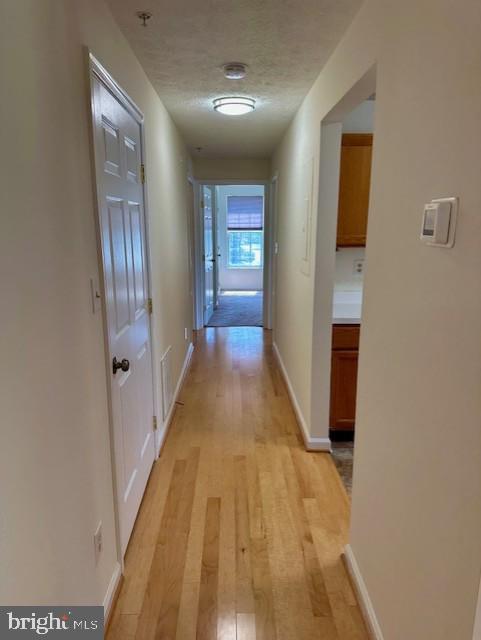 696 Winding Stream Way, Unit 104 Odenton, MD 21113 - Photo 13 of 21 a view of a hallway with wooden floor