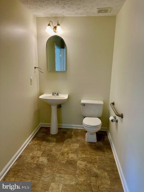696 Winding Stream Way, Unit 104 Odenton, MD 21113 - Photo 17 of 21 a bathroom with a sink toilet and a mirror