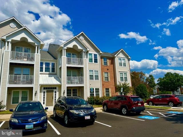 696 Winding Stream Way, Unit 104 Odenton, MD 21113 - Photo 3 of 21 a car parked in front of a house
