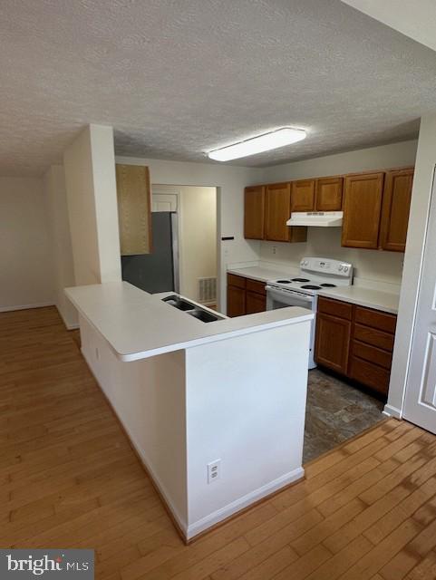 696 Winding Stream Way, Unit 104 Odenton, MD 21113 - Photo 10 of 21 a room with kitchen island stainless steel appliances a sink and a refrigerator