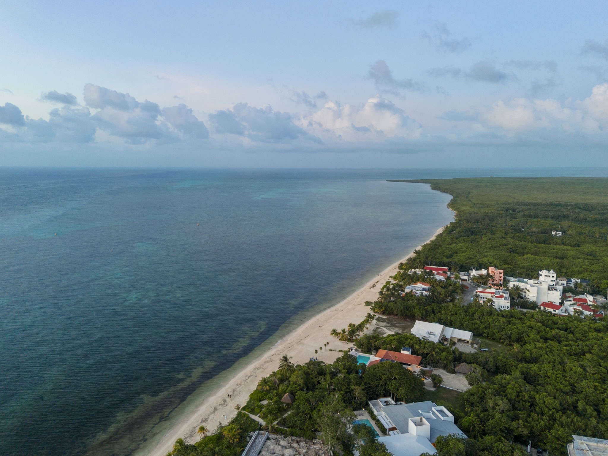 6 Country Club, Unit 4 Nome, TX 77629 - Photo 34 of 45 Cozumel’s breathtaking coastline, showcasing a magnificent stretch of white sand beach and turquoise water located just moments from the villa.