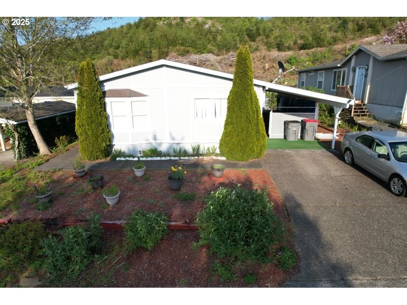481 Hillside Loop Seaside, OR 97138 - Photo 2 of 47 a view of a house with a yard and garage