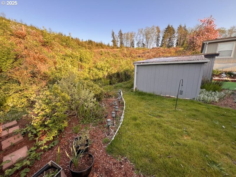 481 Hillside Loop Seaside, OR 97138 - Photo 23 of 47 a view of a garden with a building in the background