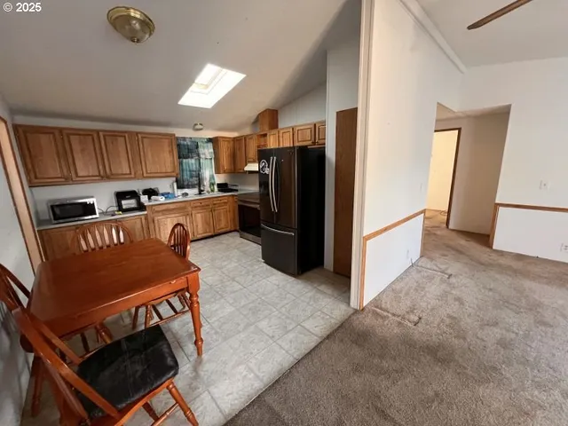 a kitchen with stainless steel appliances granite countertop a refrigerator stove microwave and sink