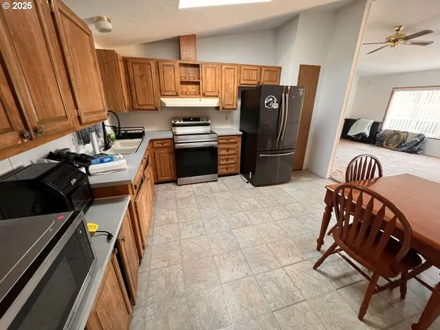 a kitchen with a refrigerator a stove a sink and dishwasher