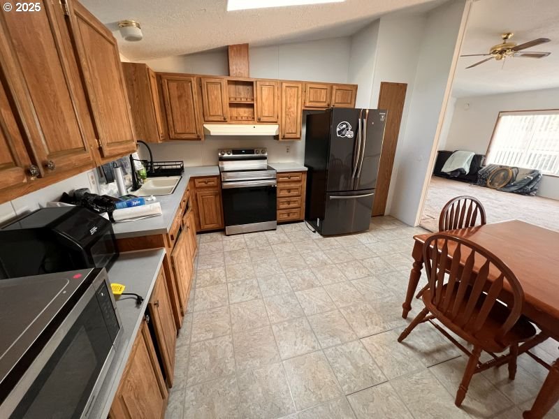 481 Hillside Loop Seaside, OR 97138 - Photo 31 of 47 a kitchen with a refrigerator a stove a sink and dishwasher