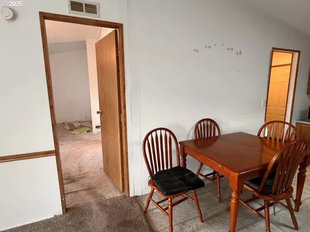 a view of an empty room with a cabinet